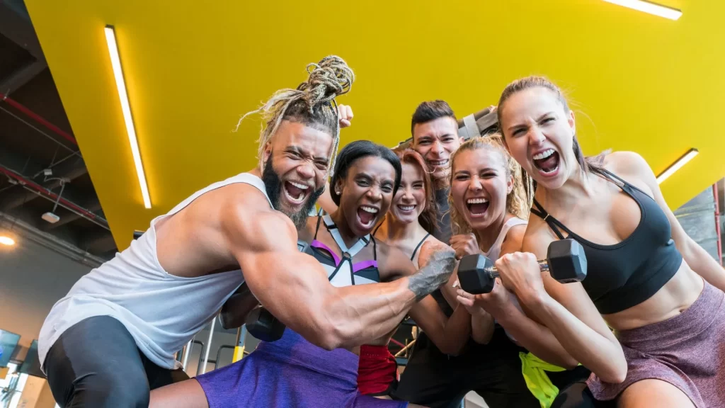 Six gym enthusiasts pose for a group photo