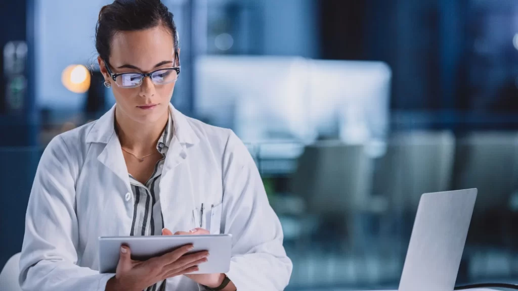 A female doctor is using their tablet to look at healthcare trends.