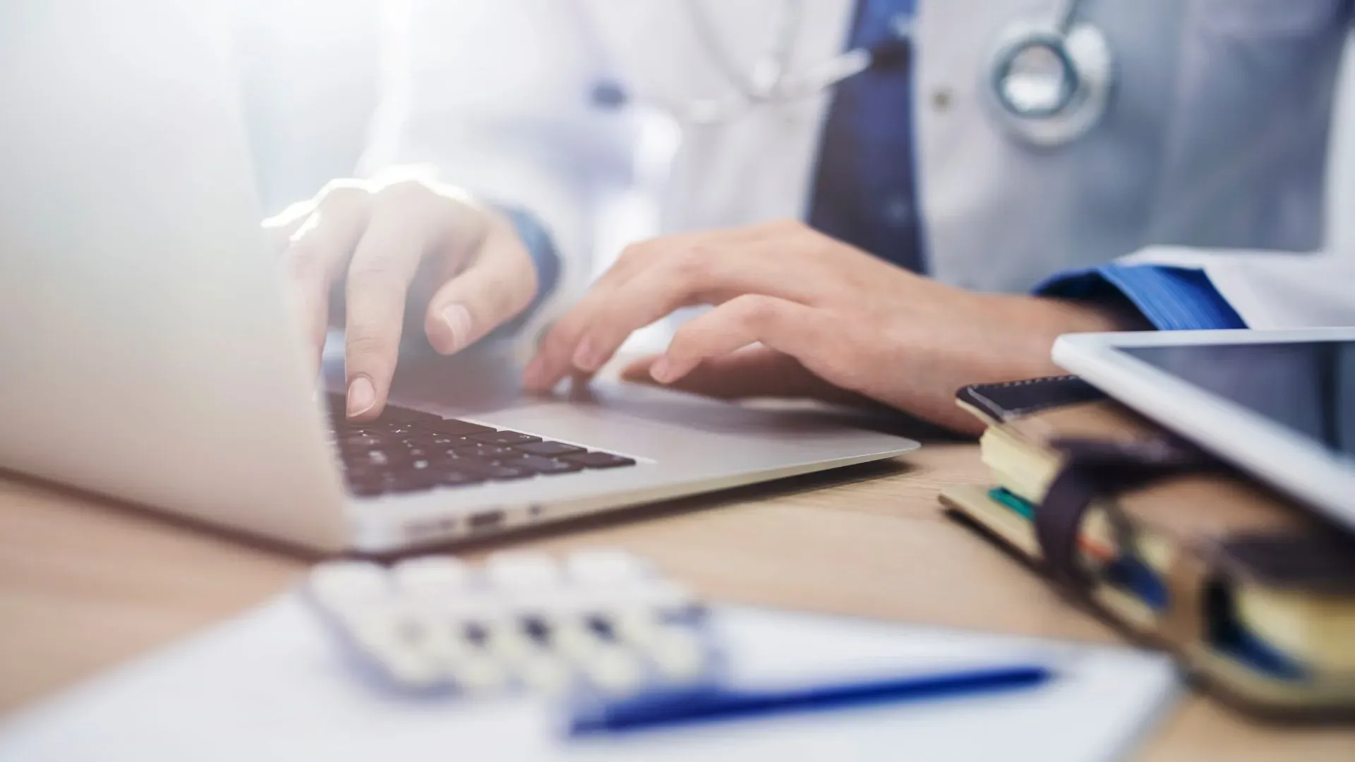 A healthcare provider using their laptop